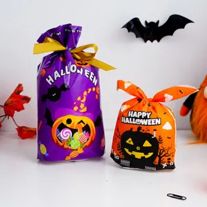 Detailed view of Halloween candy gift bags featuring cute pumpkin designs and festive packaging.