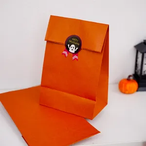 Detail view of plain orange Halloween baking paper bags for gift storage and party packaging.