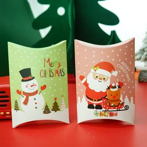Close-up detail of festive Christmas pillow gift boxes with cute snowman and Santa prints.