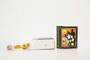 Detailed view of 2023 Halloween book-shaped gift packaging box with candies for party.
