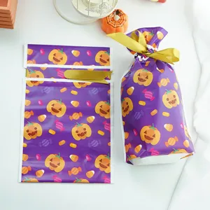 Bolsas de regalo de caramelos de Halloween con cinta dorada, lindo estampado de calabaza festiva.