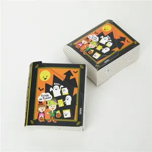 Detailed view of Halloween book shaped paper gift box with spooky cartoon designs.