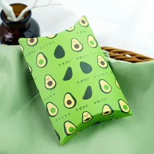 Close up of green avocado paper pillow box detail, cute snack packaging storage container.