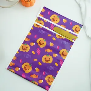 Bolsas de regalo de caramelos de Halloween con diseño de calabaza y cintas doradas.