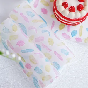 Colorful feather pattern baking wax paper detail showing translucent material for sandwich wrapping.