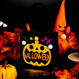 Detalle de bolsa de fieltro de Halloween con diseño de calabaza y atrezzo festivo.