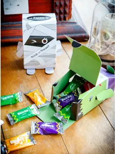 Halloween gift packaging paper boxes and cute candy boxes, creative holiday party decor setup.