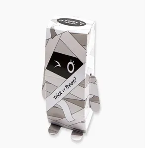Detailed view of Halloween mummy paper candy box, cute standing design with wink expression.