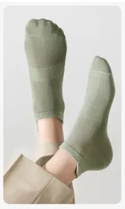 Detail view of breathable sage green mesh short socks for men, summer casual wear.