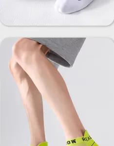 Detailed view of men's athletic short socks in breathable mesh fabric with sporty letters.