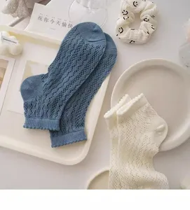 Detailed view of summer mesh lace ankle socks in blue and white, sweet ins style flat lay.