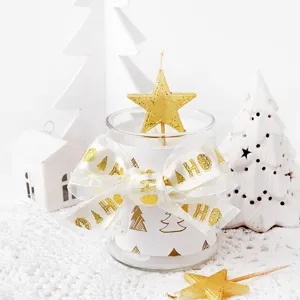 Christmas scented candle with gold star and HO HO ribbon, ideal holiday home decor gift.
