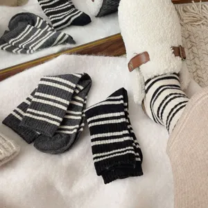 Cozy women's winter striped mid-tube socks detailed view, warm knit socks lifestyle.