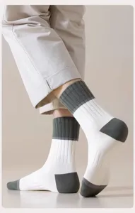 Detail view of men's crew socks showing color-block heel and toe design with comfortable fit.