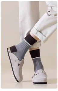 Men's mid-tube socks featuring a stylish grey and brown color-block design with white stripes.