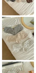 Detail view of women floral mid tube socks, comfortable cute retro grey stack socks pair.