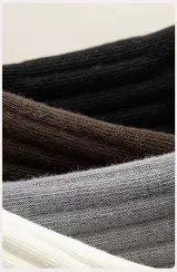 Close-up detail of ribbed knit men's socks in assorted classic colors showing soft texture.