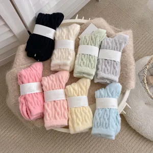 Close-up detail of plush cable knit cozy winter warm socks in soft candy colors with bands.