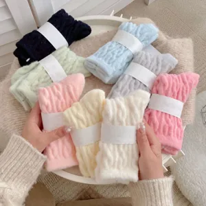 Cozy plush fuzzy mid-tube socks detail shot, soft candy colors winter warm home floor socks.