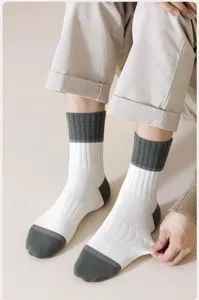Men's cotton mid-calf socks detail shot, showing breathable ribbed cuff and color-block design.