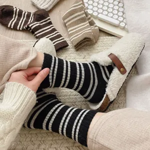 Cozy women's winter warm striped mid-tube socks detail shot, soft knitted thick thermal wear.