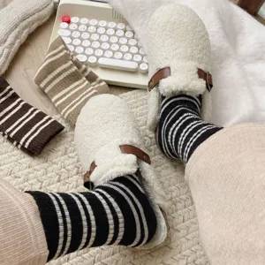 Cozy striped mid-calf socks detail shot, soft cotton thermal winter hosiery texture close-up.