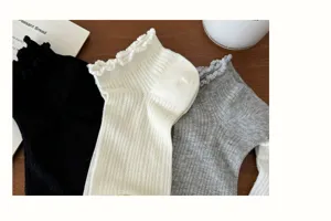 Close-up detail of women's mesh hollow-out socks featuring delicate ruffle lace trim.