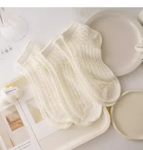 Detailed view of white mesh lace summer socks, breathable hollow out design for women.