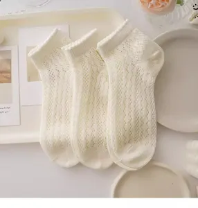 Detailed view of white lace mesh ankle socks, breathable sweet style cute design.
