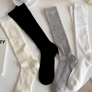 Women solid color vertical stripe mid-high socks, minimalist style casual daily wear.