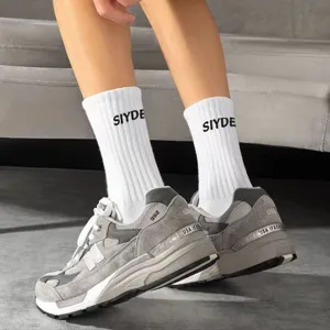 Men's white crew socks with black letter print, trendy cotton athletic sports long socks.