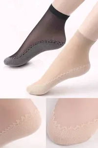 Close-up detail of sheer women socks showing anti-slip wavy sole grip and reinforced toe.