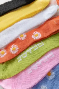 Detailed close-up shot of colorful summer ice silk mesh socks featuring cute daisy patterns.