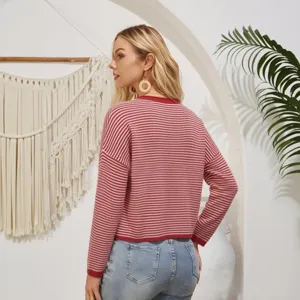 Detail shot of a women striped knit sweater showing texture and cozy autumn style.