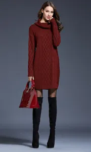 Detail view of a cozy maroon cable-knit cowl-neck sweater dress worn by a model with boots.