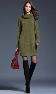 Green turtleneck cable knit sweater dress styled with boots and a handbag. Detail shot.