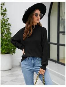 Close-up detail of the black turtleneck knitted sweater showcasing the soft fabric and fit.