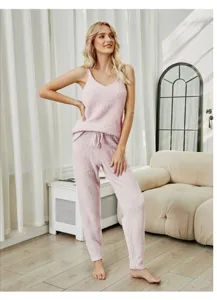 Pink fuzzy plush pajama set with cozy camisole and soft long pants for warm winter homewear look.