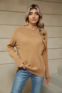 Detailed view of a solid color boat neck long sleeve knit sweater for women, comfortable style.