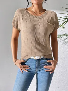 Textured knit short sleeve top detail with checkered pattern and pocket on soft fabric.