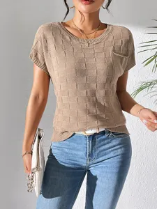 Details of the beige knit short sleeve top showing its fine checkerboard texture and crew neckline.