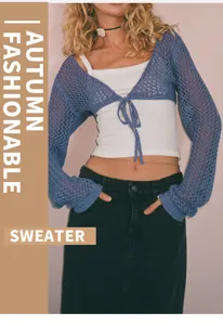 Gros plan d'un élégant bolero en tricot ajouré court avec des manches longues et un lien.