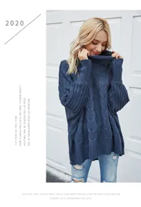 Detail shot of women's chunky turtleneck cable knit batwing sweater in dark blue.