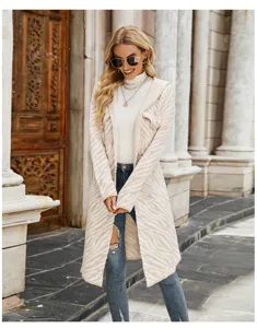 Detailed shot of women's long hooded zebra striped knit cardigan sweater in casual outdoor style.