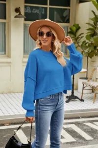 Detailed shot of a stylish blue long sleeve crewneck knit sweater, loose casual short pullover.