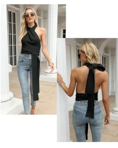 Detail view of stylish black halter knit crop top featuring open back and long waist tie.