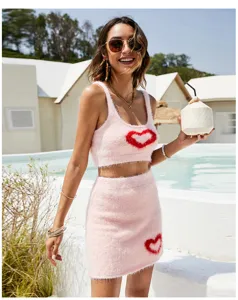 Pink fuzzy crop top mini skirt set resort poolside detail view soft knit heart motif outfit