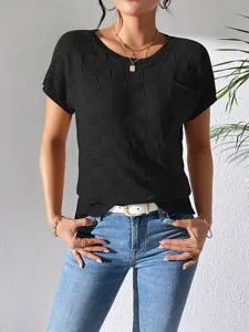Detailed view of women's black short sleeve knit t-shirt with textured check pattern design.