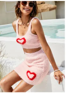 Pink fuzzy heart knit crop top and skirt set, sweet sleeveless style, detailed shot.