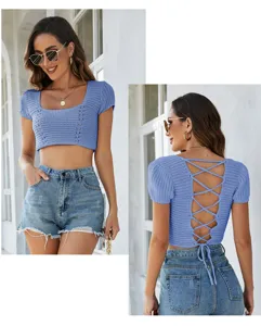 Close up detail of women blue crochet crop top with hollow out design and lace up back.